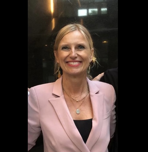 Sofia Pelletier smiles in a pink blazer.