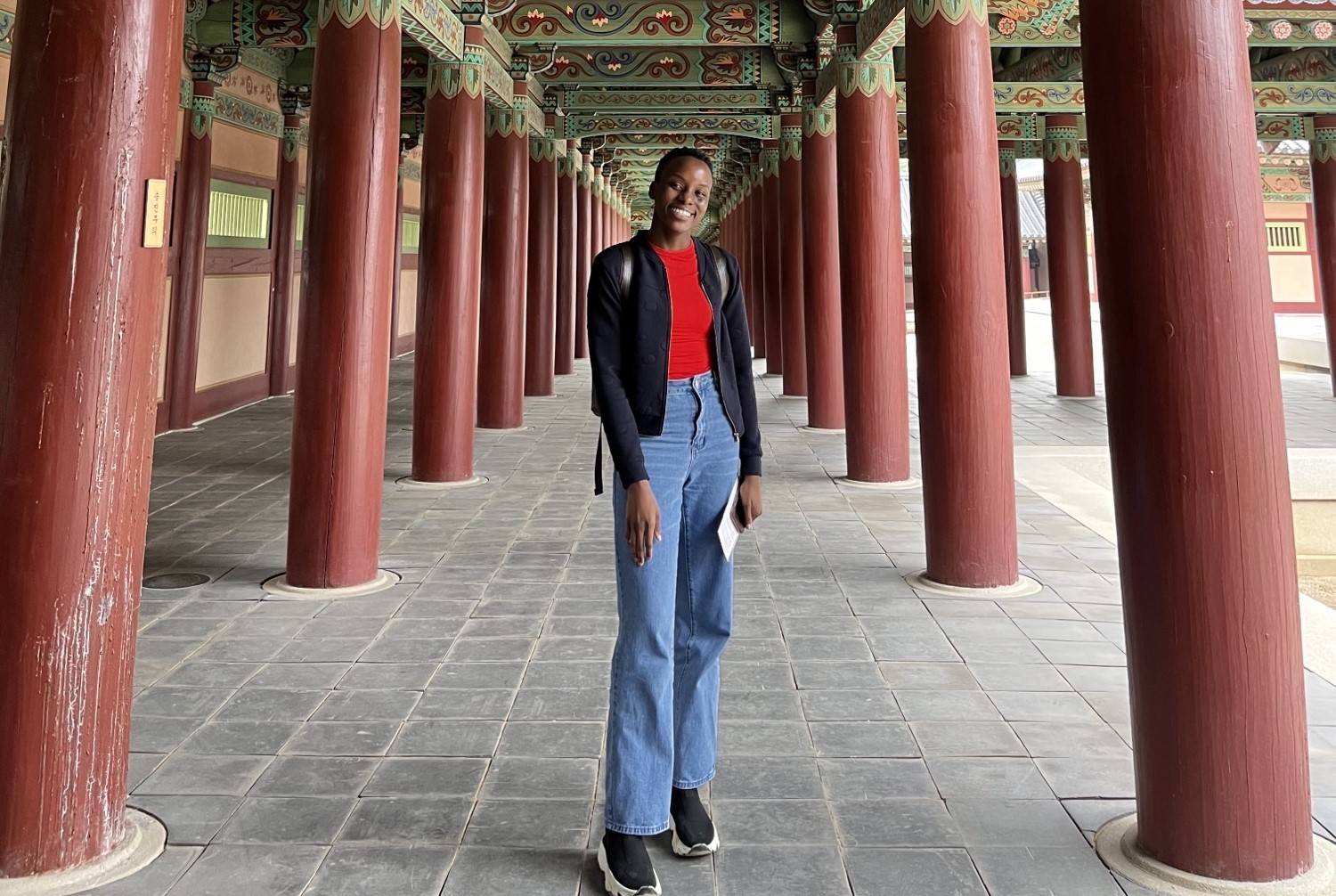 Black woman posing in front of a pagoda