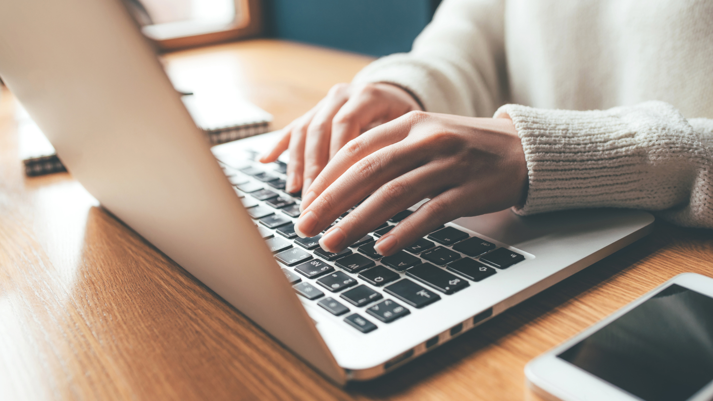 Someone typing on a computer