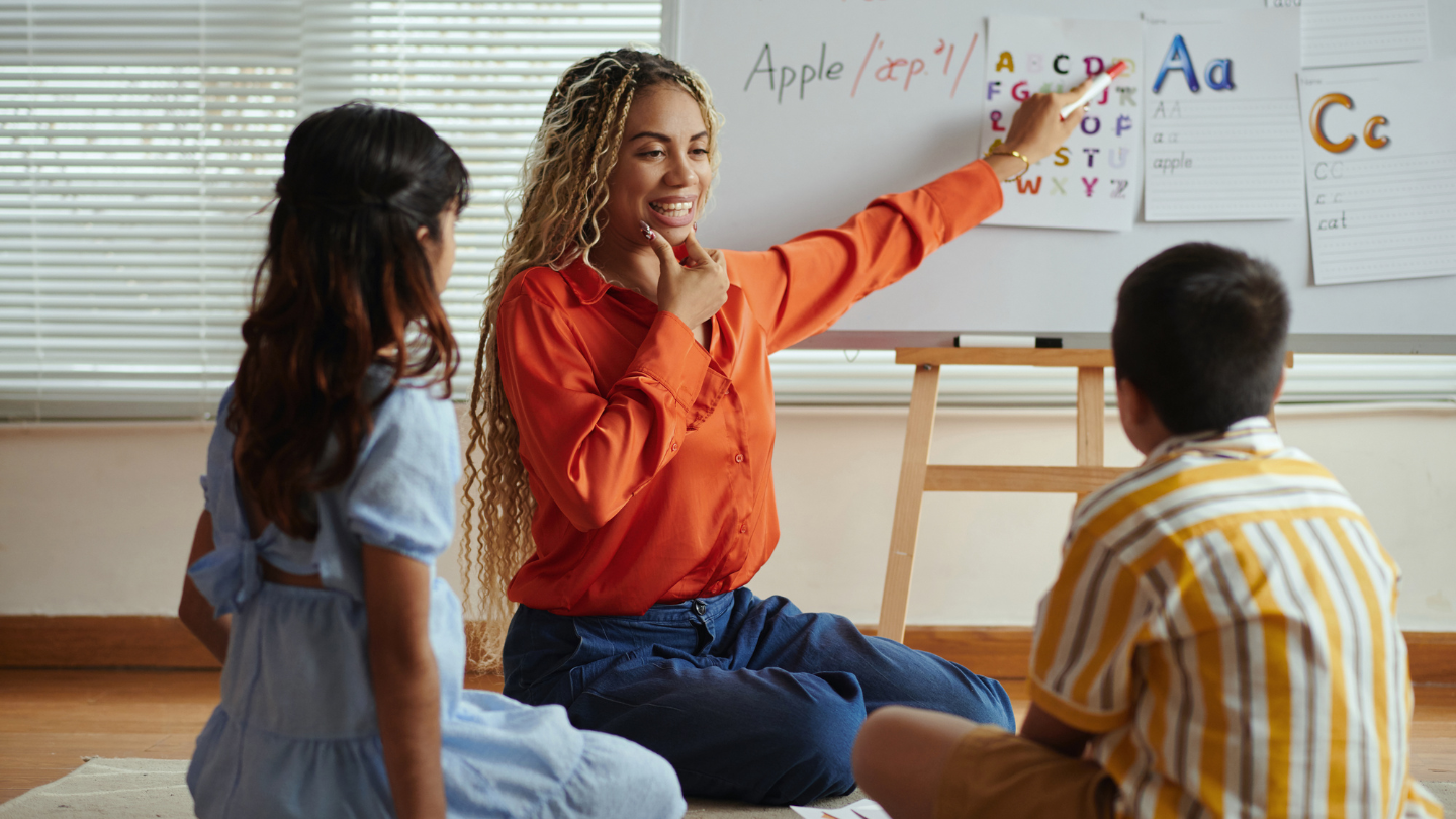 a teacher teaching two students