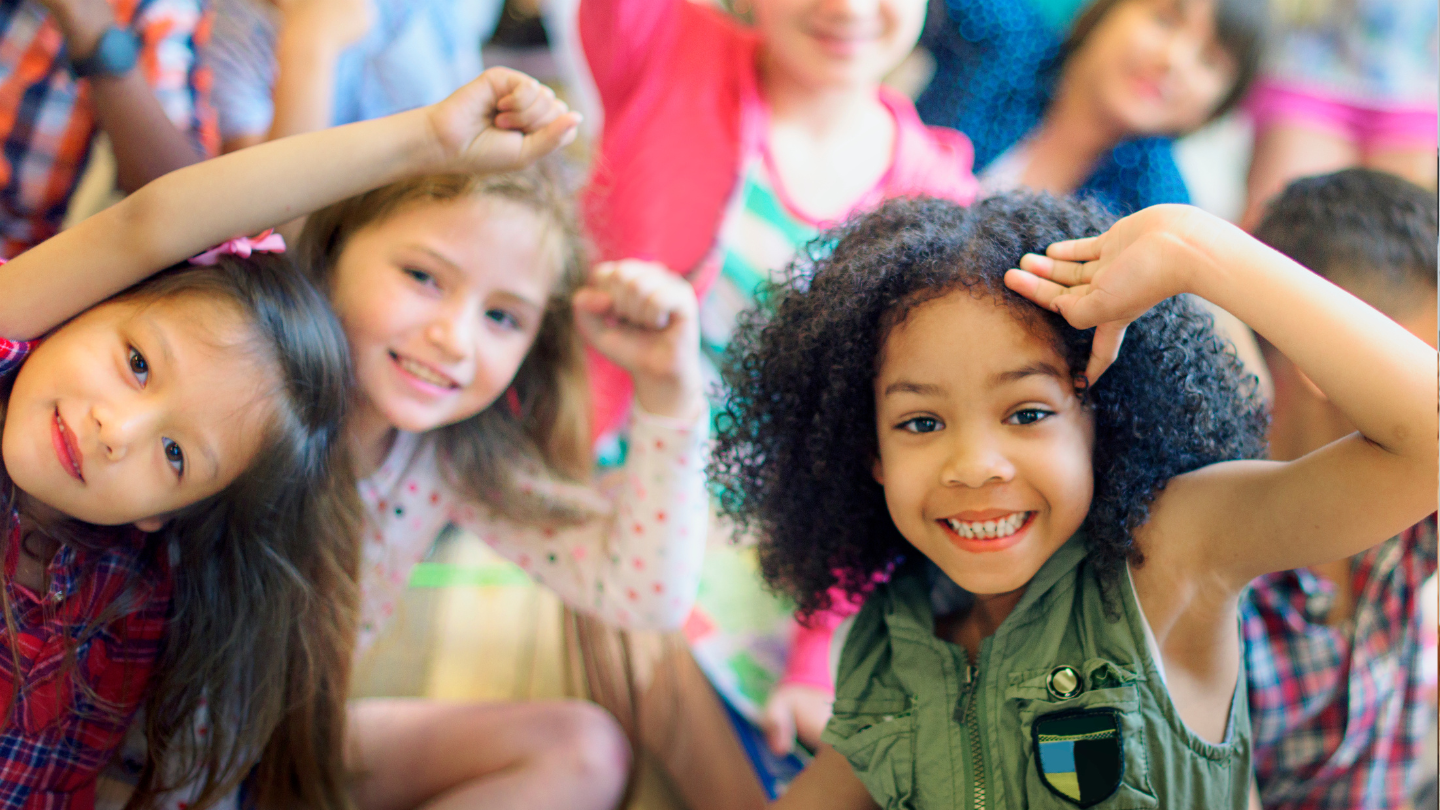 a group of children smiling at the camera
