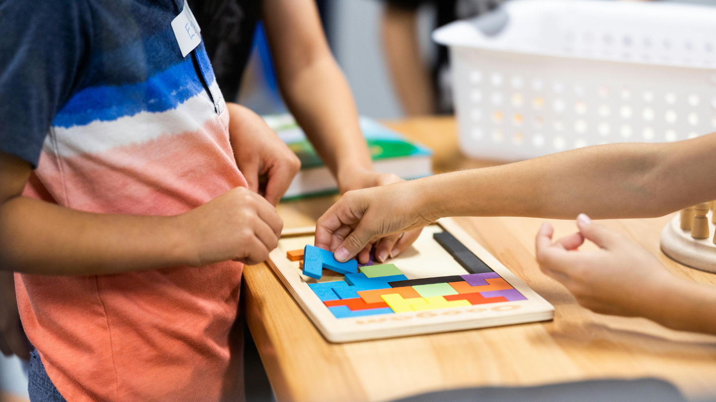 a group of kids making a puzzle