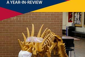 a dinosaur sculptures made out of wood with a mask on it the words 2020 a year in review and the Faculty of Education with the Queen's Logo