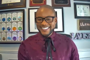 Dr Andrew Campbell smiling during online conversation