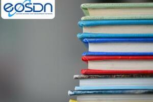 A photo of books with different colours featuring the EOSDN network logo