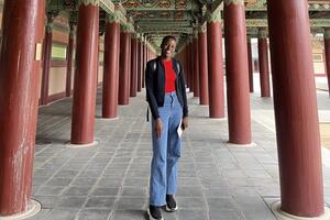 A black woman posing in front of a pagoda