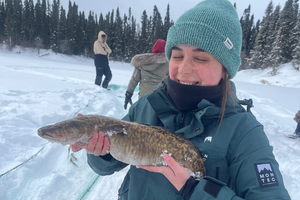 Maya Davidson holding a large fish in the snow