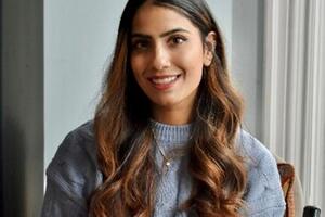 An Indian woman wearing a blue sweater