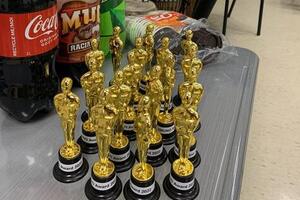 Gold statuettes standing on a table.