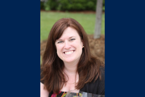 Kim Hutchinson Lewis smiles outside.