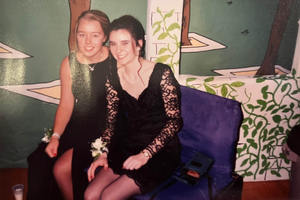 Laura Southall poses with a friend at a formal in a film photo.