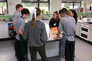 Student and teacher candidates at Chiltern Academy creating a meal