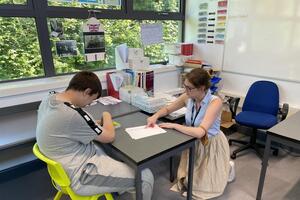 Chiltern Way story - a teacher works at a desk with a student 