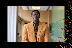 Ikeoluwapo Baruwa smiles in a hallway. There is a black border with yellow, red, and green arrows overlayed on the right side.