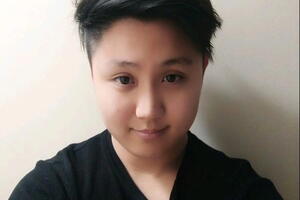 David Lyu smiles wearing a black t-shirt.