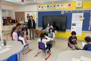 Ngwaagan Eshkibok in a classroom with students