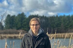 Jackson Pind smiling in front of a river
