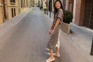 Jenny smiling in a classic alleyway