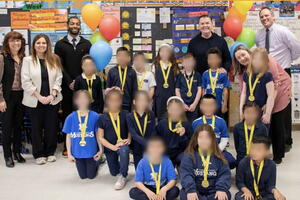 A celebration with a group of students with blurred faces and administrators