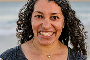 A woman smiling on a beach