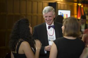 Three people at an alumni event talking 
