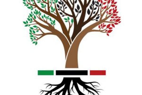 A tree with green, black and red leaves and roots that are black at the bottom 