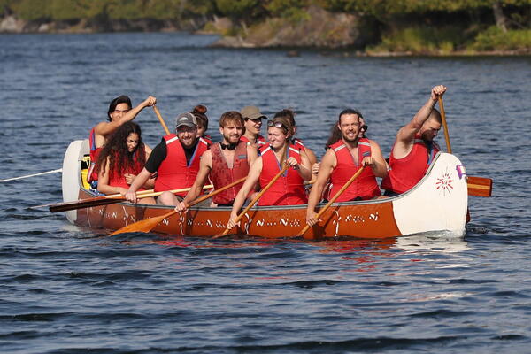 A group of people paddling in a canoe