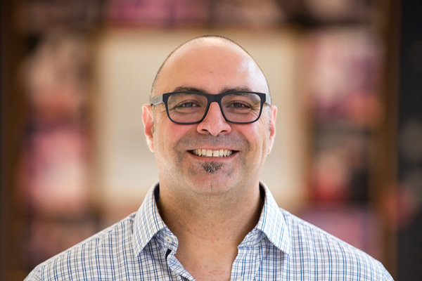Saad Chahine smiles in a hallway.