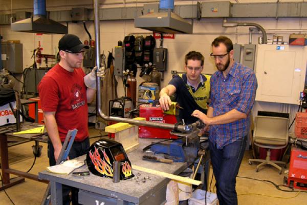 3 students working together in tech shop