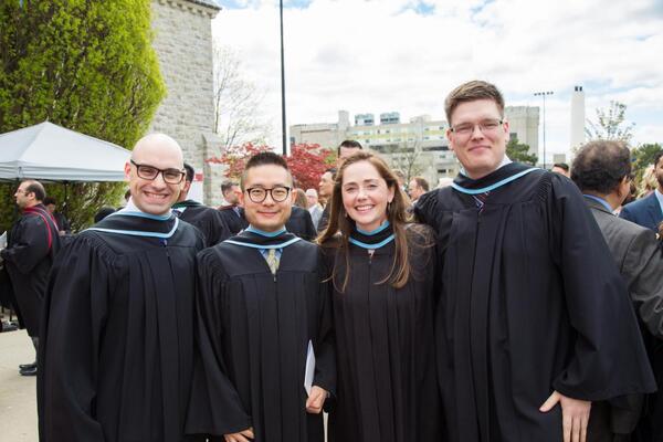 four med students at convocation
