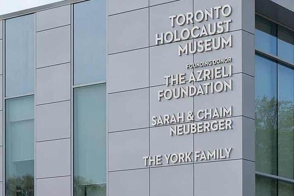 A grey rectangular building with large windows and the words Toronto Holocaust Museum 
