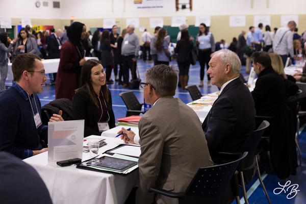 Four people around a table at a job fair