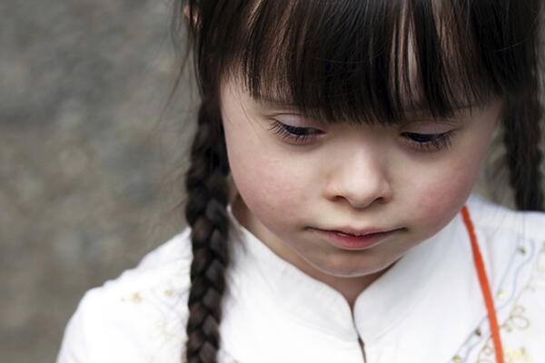a child looking down from the camera