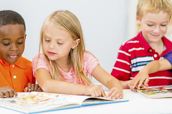 a group of primary students reading