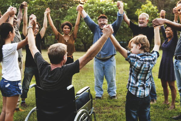 a group of people holding hands in a park