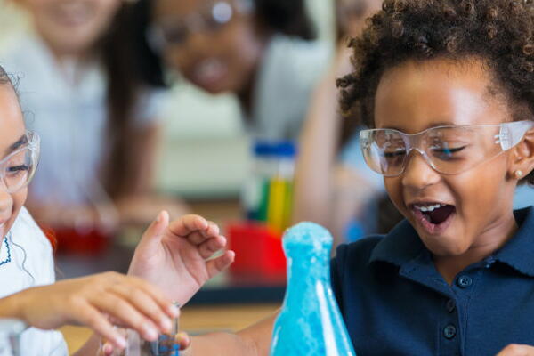 a group of kids in a chemistry lab