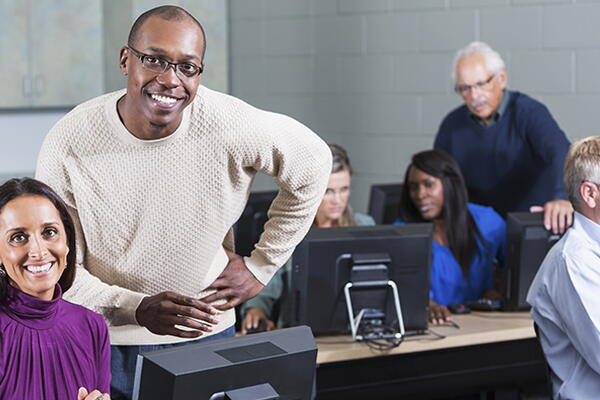 a group of adults in a classroom