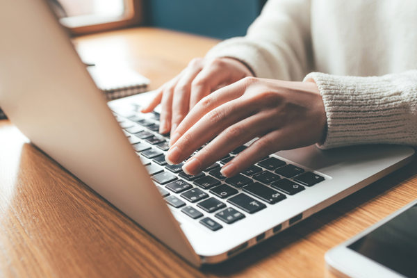 Someone typing on a computer