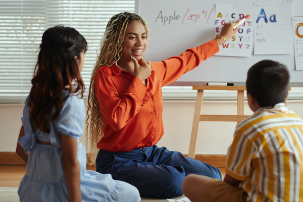 a teacher teaching two students