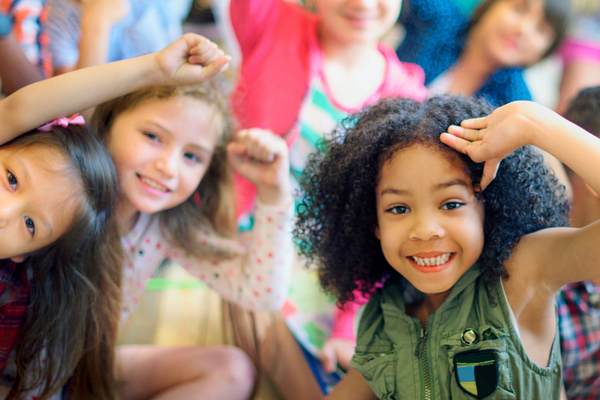 a group of children smiling at the camera