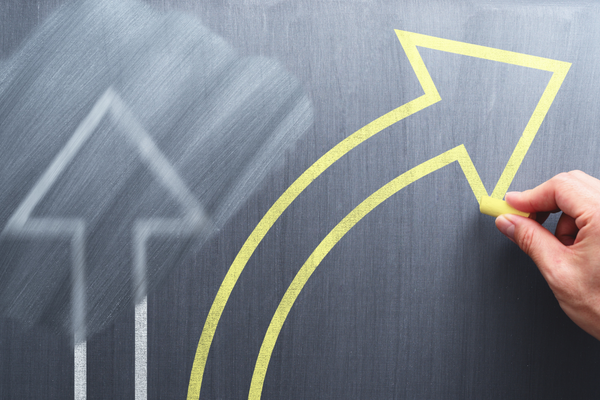 a straight arrow being erased for an arrow going sideways depicting change