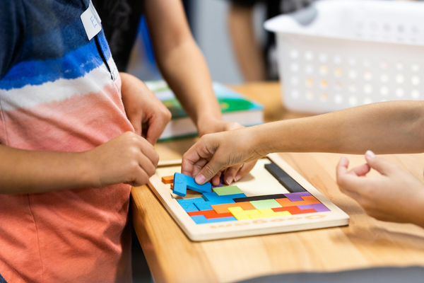a group of kids making a puzzle