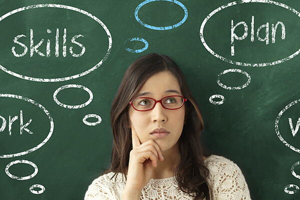 a person standing in front of a chalkboard with career growth skills written on it