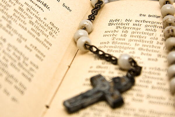 a cross necklace put on the bible