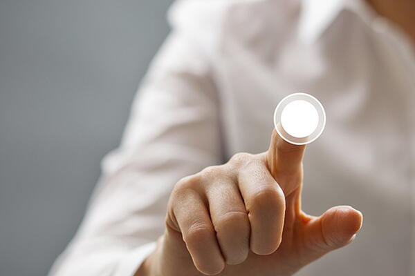 a person interacting with a glass smart board