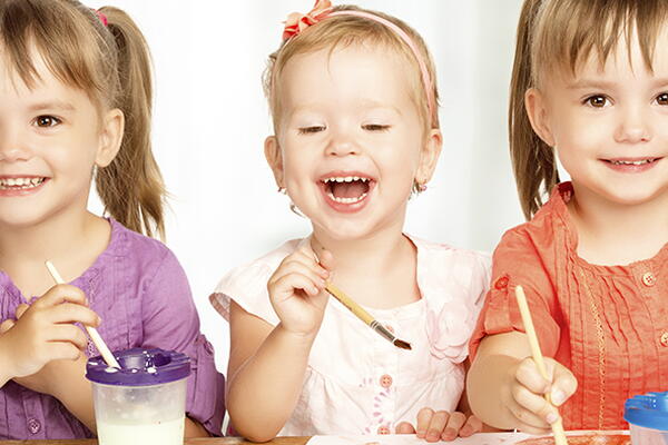 a group of children smiling at the camera