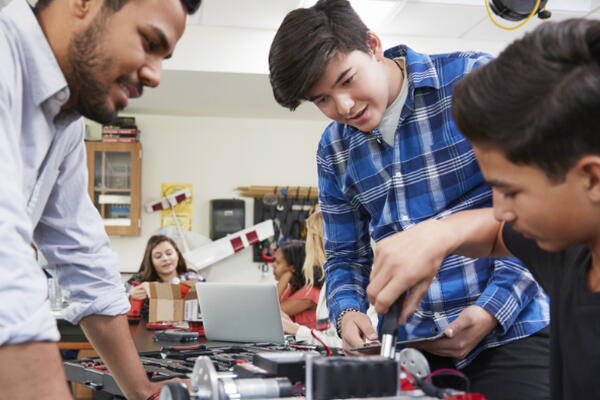 a group of students and their teacher building something