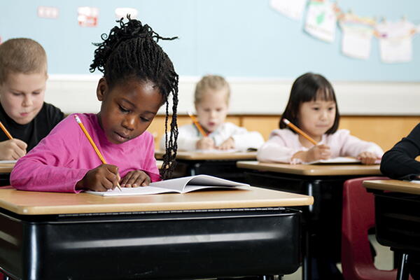 students working on their notebooks in a classroom