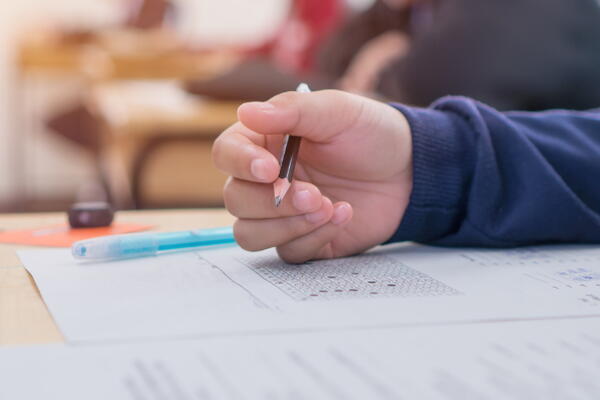 a picture of someone's hand while they're taking a test