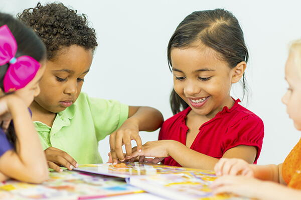 a group of kindergarden students working together in a classroom
